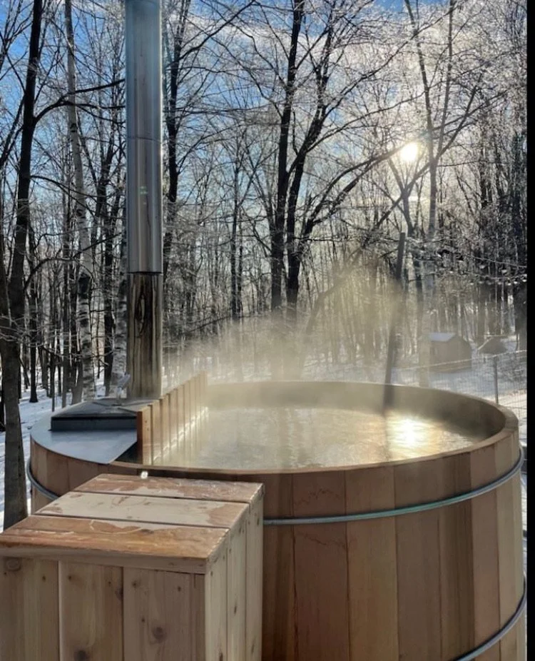 Cedar hot tub in a Hudson Valley outdoor setting with trees