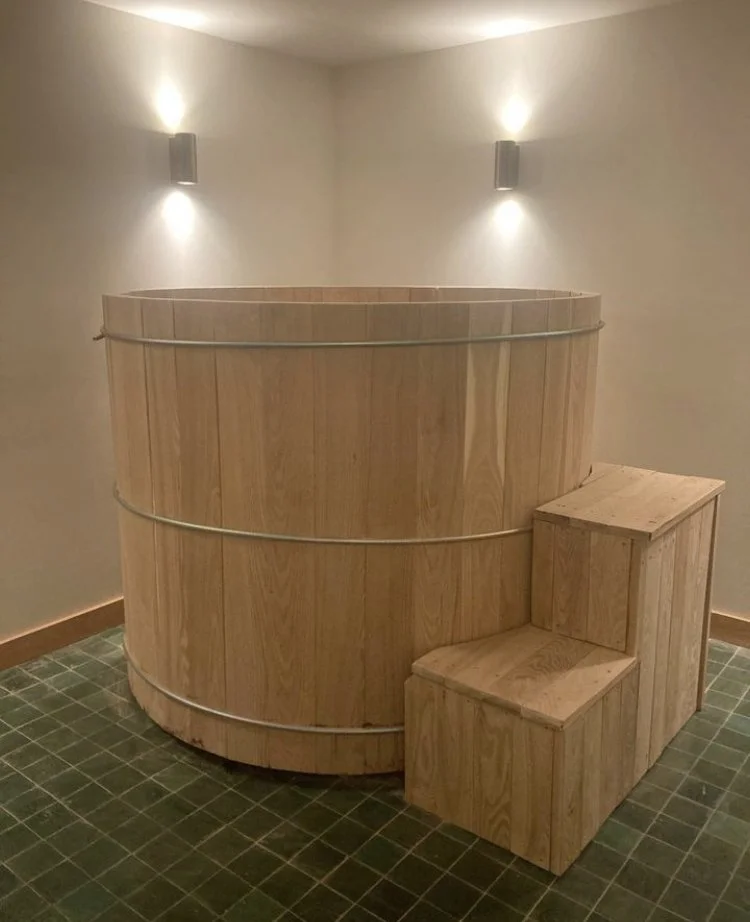 Cedar hot tub installed on a deck with natural cedar surround