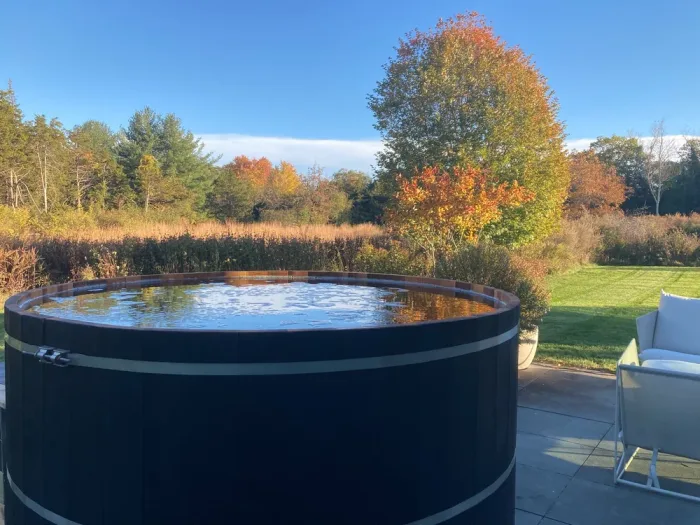 Cedar hot tub on a covered porch with mountain views